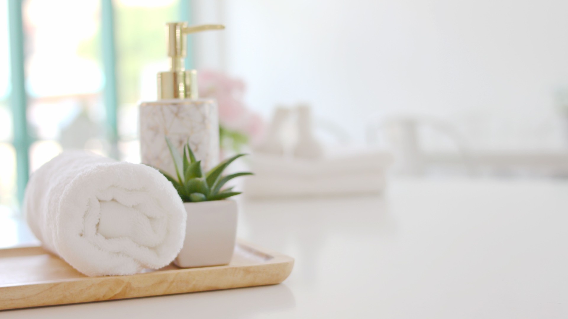 Roll up of white towels on white table with copy space Spa concept