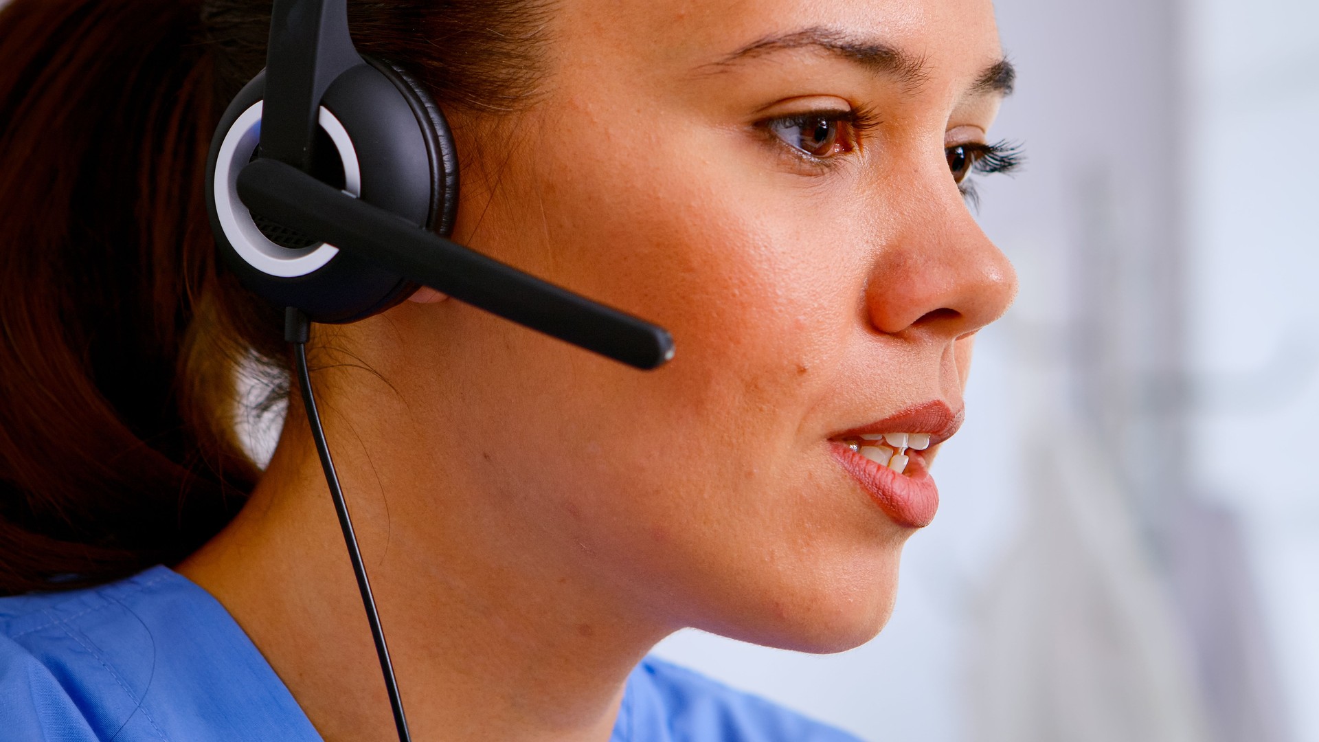 Close up of medical operator with headphone consulting patients
